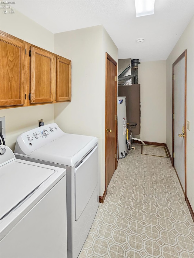 110 Orchard Grove Dr, Clyde, OH 43410 - washroom with washing machine and dryer, cabinet space, water heater, and baseboards