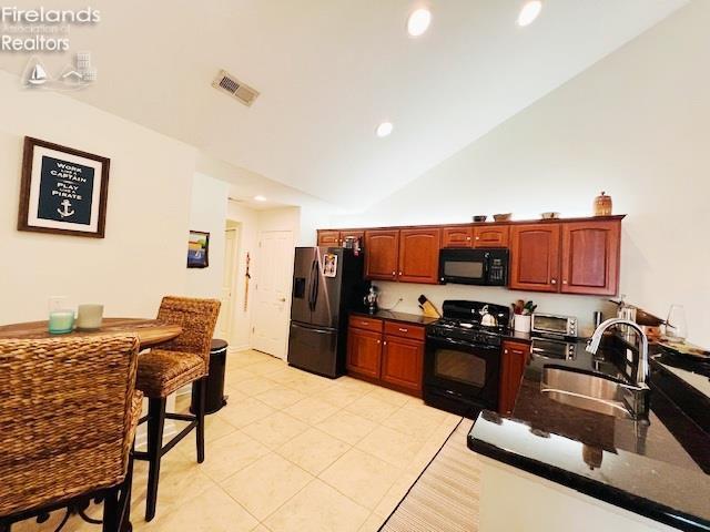 2780 Canterbury Ln Unit A, Port Clinton, OH 43452 - kitchen featuring black appliances, a sink, lofted ceiling, light tile patterned floors, and recessed lighting