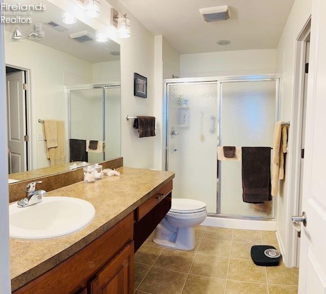 2780 Canterbury Ln Unit A, Port Clinton, OH 43452 - full bath featuring tile patterned floors, a stall shower, vanity, and toilet