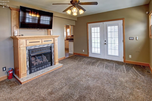 5475 E Mabel Dr, Port Clinton, OH 43452 - unfurnished living room featuring french doors, ceiling fan, baseboards, carpet, and a fireplace
