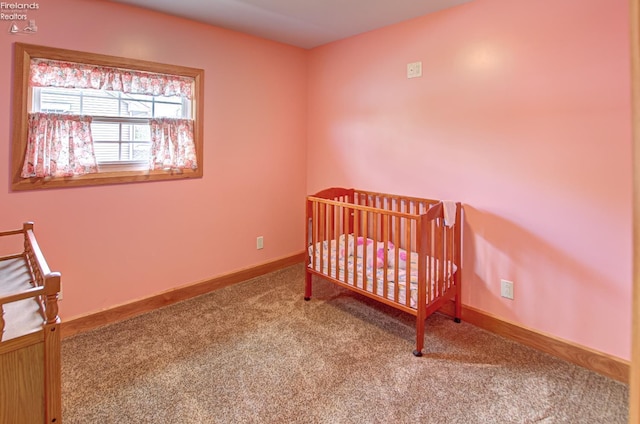 5475 E Mabel Dr, Port Clinton, OH 43452 - carpeted bedroom with baseboards and a nursery area