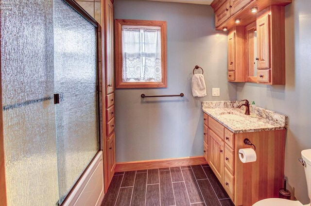5475 E Mabel Dr, Port Clinton, OH 43452 - bathroom featuring toilet, wood finish floors, baseboards, and vanity