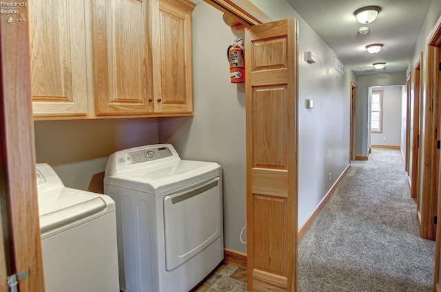 5475 E Mabel Dr, Port Clinton, OH 43452 - laundry area featuring washer and clothes dryer, cabinet space, carpet floors, and baseboards