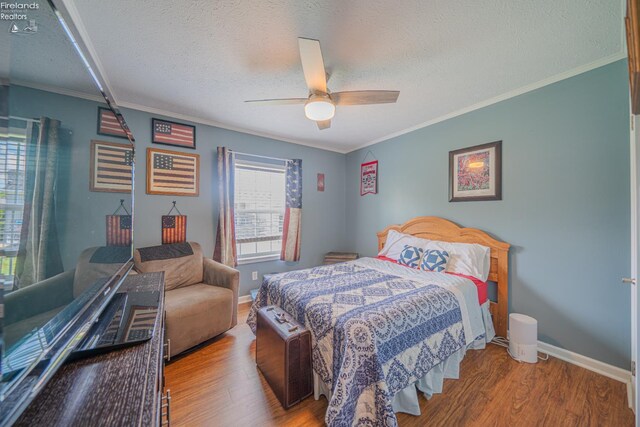 8896 White Crane Way, Oak Harbor, OH 43449 - bedroom with wood finished floors, a textured ceiling, baseboards, crown molding, and ceiling fan