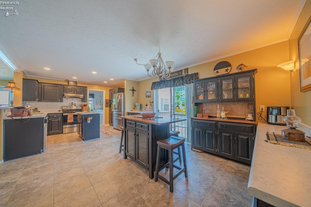 8896 White Crane Way, Oak Harbor, OH 43449 - kitchen with stainless steel appliances, a kitchen island, backsplash, a chandelier, and recessed lighting