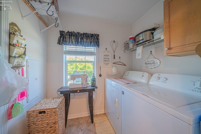 8896 White Crane Way, Oak Harbor, OH 43449 - washroom with cabinet space, washing machine and clothes dryer, and baseboards