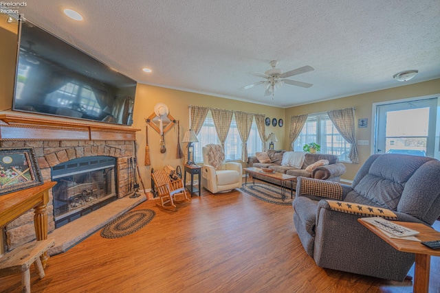 8896 White Crane Way, Oak Harbor, OH 43449 - living area featuring a textured ceiling, wood finished floors, a fireplace, ceiling fan, and recessed lighting