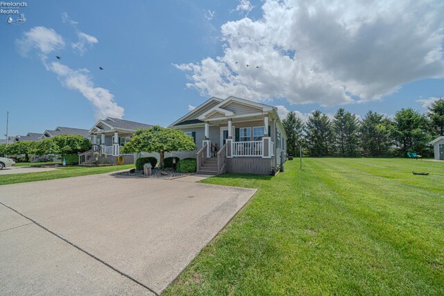 8896 White Crane Way, Oak Harbor, OH 43449 - view of front of house with covered porch and a front lawn