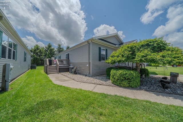 8896 White Crane Way, Oak Harbor, OH 43449 - view of side of home featuring a yard, a wooden deck, and central AC