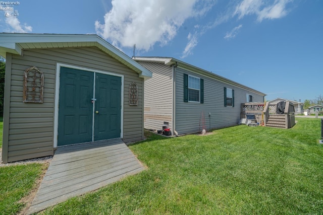 8896 White Crane Way, Oak Harbor, OH 43449 - back of house featuring a yard, an outbuilding, and a storage shed