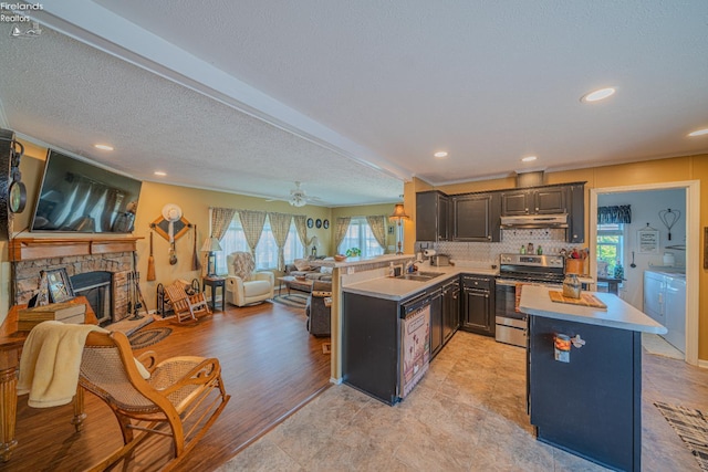 8896 White Crane Way, Oak Harbor, OH 43449 - kitchen with stainless steel electric range oven, separate washer and dryer, a sink, open floor plan, and under cabinet range hood