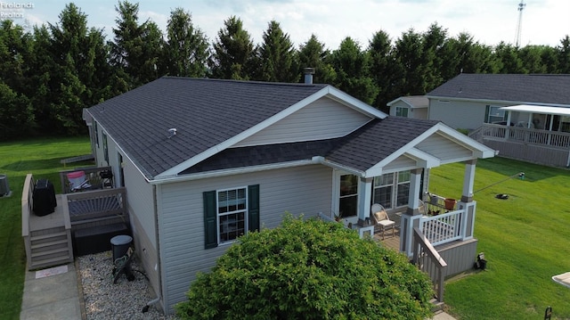 8896 White Crane Way, Oak Harbor, OH 43449 - view of front of house featuring a shingled roof, a deck, and a front lawn