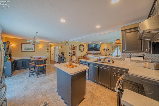8896 White Crane Way, Oak Harbor, OH 43449 - kitchen with electric range, a sink, extractor fan, light countertops, and a chandelier