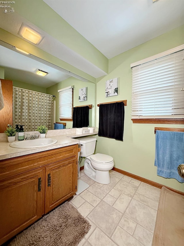 38 N Tecumseh Trl, Tiffin, OH 44883 - bathroom with vanity, toilet, baseboards, and a shower with curtain