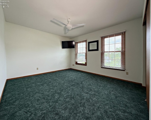 38 N Tecumseh Trl, Tiffin, OH 44883 - unfurnished room featuring dark colored carpet, baseboards, and a ceiling fan