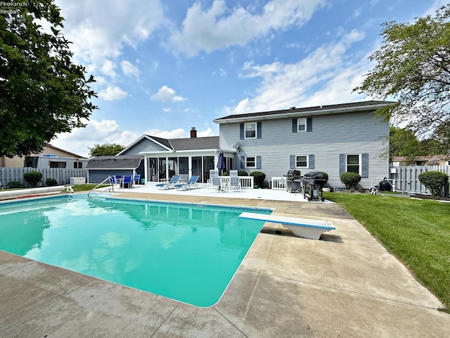 38 N Tecumseh Trl, Tiffin, OH 44883 - view of swimming pool featuring a patio, a diving board, a sunroom, and a grill