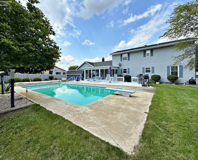 38 N Tecumseh Trl, Tiffin, OH 44883 - view of swimming pool featuring a patio, a sunroom, area for grilling, and a diving board