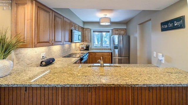 3088 N Marina View Dr Unit 12, Port Clinton, OH 43452 - kitchen with appliances with stainless steel finishes, a sink, light stone countertops, backsplash, and brown cabinetry