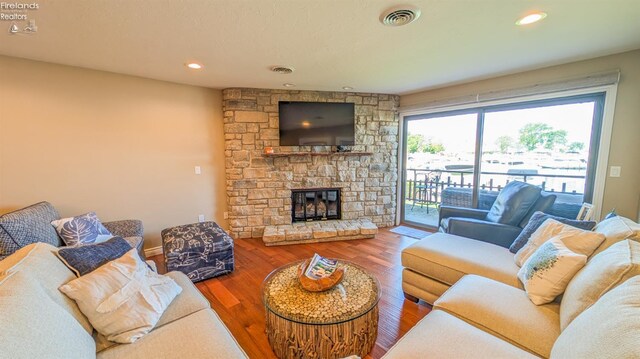 3088 N Marina View Dr Unit 12, Port Clinton, OH 43452 - living room featuring a stone fireplace, wood finished floors, and recessed lighting