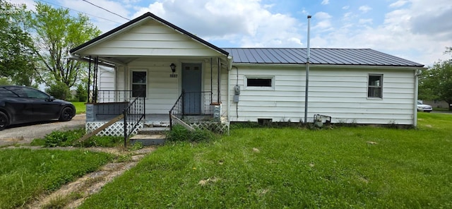 1037 Fishlock Ave, Findlay, OH 45840 - view of front facade with metal roof, a front lawn, and a porch