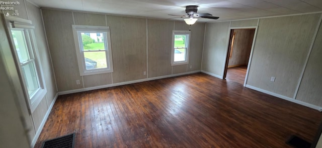 1037 Fishlock Ave, Findlay, OH 45840 - unfurnished room with dark wood-type flooring, ceiling fan, baseboards, and crown molding