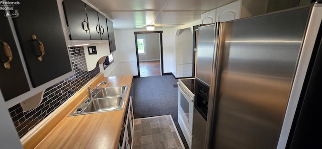 1037 Fishlock Ave, Findlay, OH 45840 - kitchen featuring freestanding refrigerator, a sink, and dark cabinets