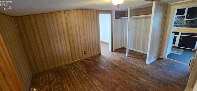 1037 Fishlock Ave, Findlay, OH 45840 - unfurnished bedroom featuring wood finished floors, a textured ceiling, and wooden walls