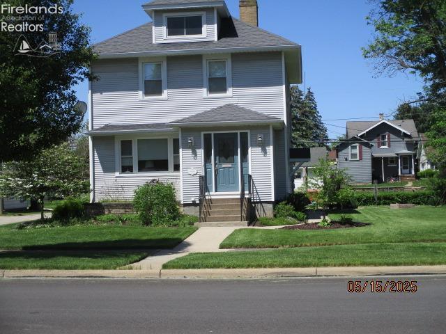 720 S Myrtle Ave, Willard, OH 44890 - american foursquare style home with a chimney and a front yard