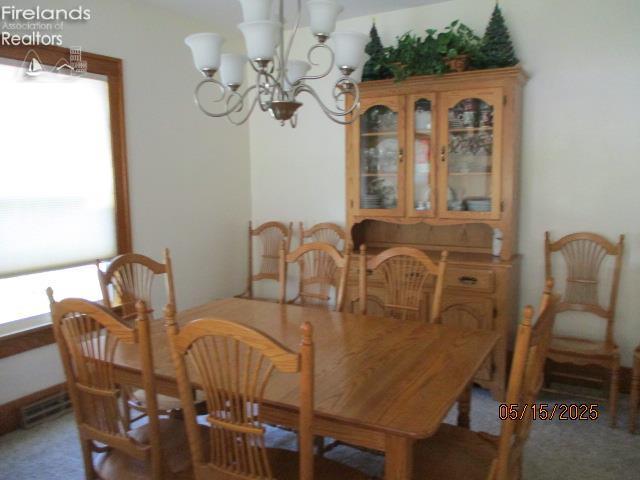 720 S Myrtle Ave, Willard, OH 44890 - dining space with a chandelier and carpet flooring