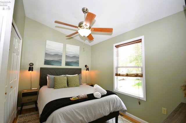 765 Riverside, Vermilion, OH 44089 - bedroom with a closet, baseboards, wood finished floors, a ceiling fan, and lofted ceiling