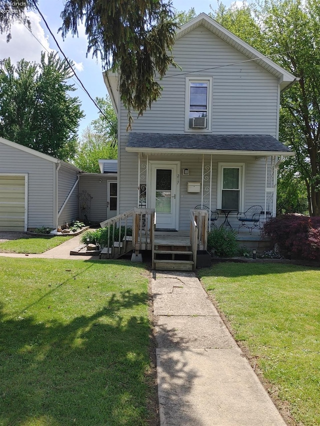 217 N Mulberry St, Clyde, OH 43410 - view of front of house with a porch, a front yard, and cooling unit