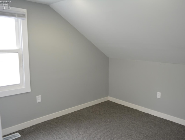 26 Marshall St, Norwalk, OH 44857 - bonus room with vaulted ceiling, dark carpet, healthy amount of natural light, and baseboards