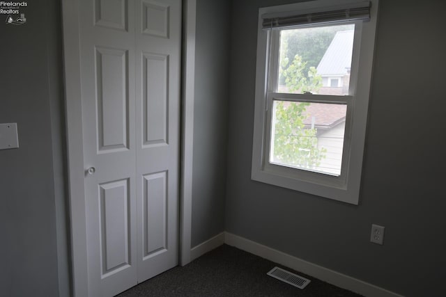 26 Marshall St, Norwalk, OH 44857 - unfurnished bedroom with dark colored carpet, baseboards, and a closet