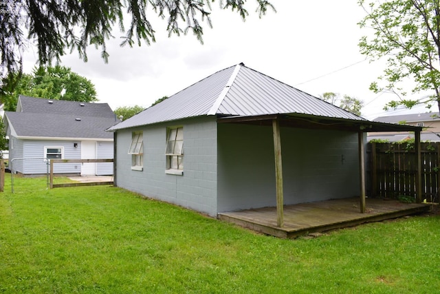 26 Marshall St, Norwalk, OH 44857 - rear view of property with concrete block siding, metal roof, and a wooden deck