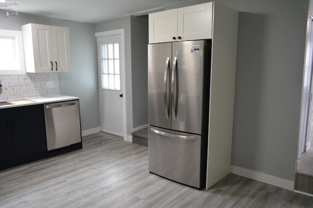 26 Marshall St, Norwalk, OH 44857 - kitchen with stainless steel appliances, a sink, baseboards, and light wood finished floors
