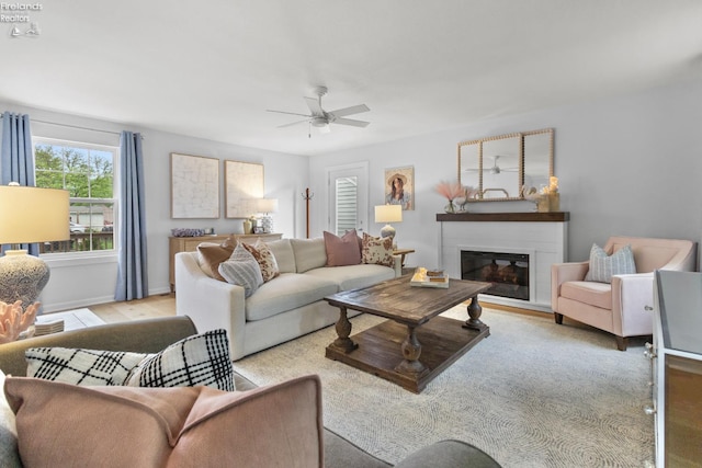 625 Laurel Ave, Port Clinton, OH 43452 - living area with a ceiling fan, a glass covered fireplace, wood finished floors, and baseboards