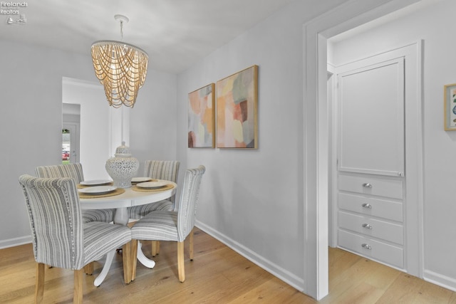 625 Laurel Ave, Port Clinton, OH 43452 - dining room with a chandelier, light wood-style flooring, and baseboards