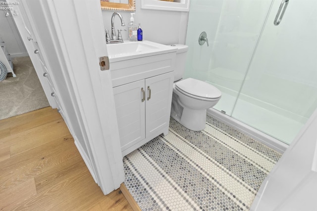 625 Laurel Ave, Port Clinton, OH 43452 - bathroom featuring a stall shower, toilet, vanity, and wood finished floors