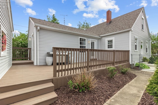 625 Laurel Ave, Port Clinton, OH 43452 - back of property with a deck, a chimney, a shingled roof, and fence