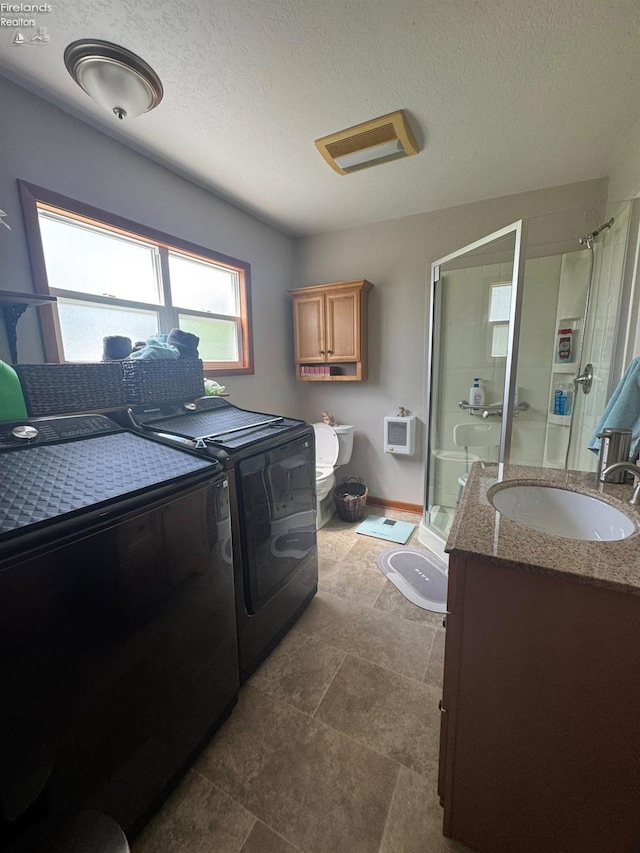 1168 Platt St, Martin, OH 43445 - washroom with washing machine and clothes dryer, a textured ceiling, and baseboards