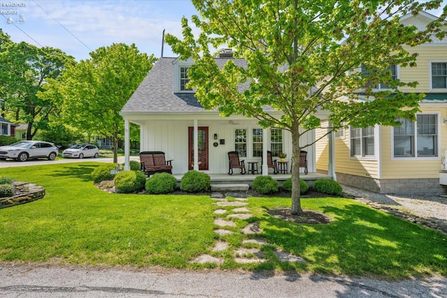 236 Elm Ave, Lakeside, OH 43440 - view of front facade featuring a porch, a front lawn, a chimney, and roof with shingles
