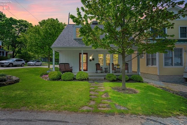 236 Elm Ave, Lakeside, OH 43440 - view of front of home with covered porch, a lawn, a chimney, and roof with shingles