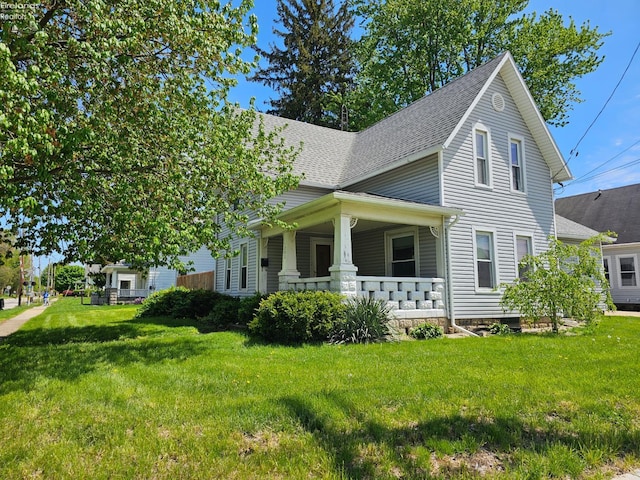 202 Duane St, Clyde, OH 43410 - view of home's exterior featuring a porch, a lawn, and a shingled roof