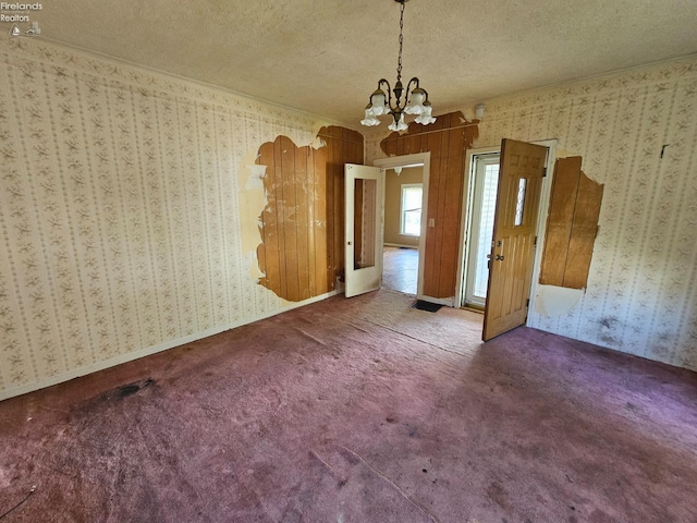 202 Duane St, Clyde, OH 43410 - unfurnished dining area with a textured ceiling, a chandelier, wallpapered walls, carpet, and crown molding