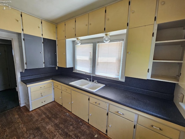 202 Duane St, Clyde, OH 43410 - kitchen with cream cabinetry, a sink, dark wood-style flooring, and dark countertops