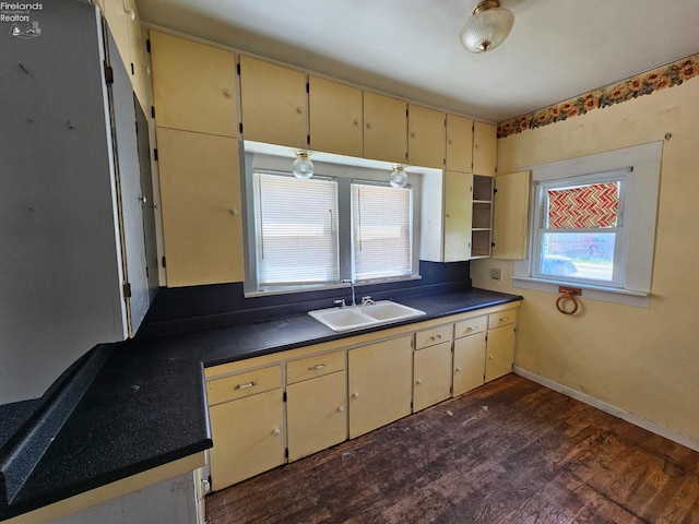 202 Duane St, Clyde, OH 43410 - kitchen featuring cream cabinets, dark countertops, dark wood finished floors, and a sink