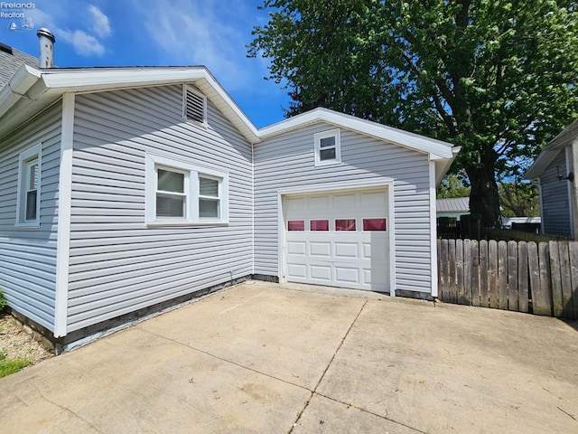 202 Duane St, Clyde, OH 43410 - view of side of property featuring concrete driveway, fence, and a garage