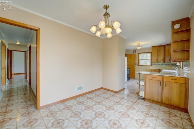419 Kinney St, Bellevue, OH 44811 - kitchen featuring open shelves, light countertops, a sink, a chandelier, and ornamental molding