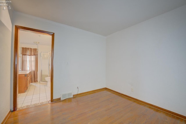 419 Kinney St, Bellevue, OH 44811 - spare room with light wood-style flooring and baseboards