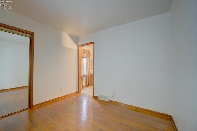 419 Kinney St, Bellevue, OH 44811 - spare room with wood finished floors, baseboards, and ornamental molding
